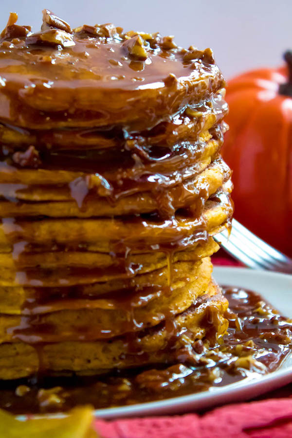 These Pumpkin Pancakes are light, fluffy and has the perfect amount of pumpkin and spice flavour! Topped with a rich and delicious Maple Pecan Praline Syrup, these irresistible pancakes are the perfect fall breakfast!