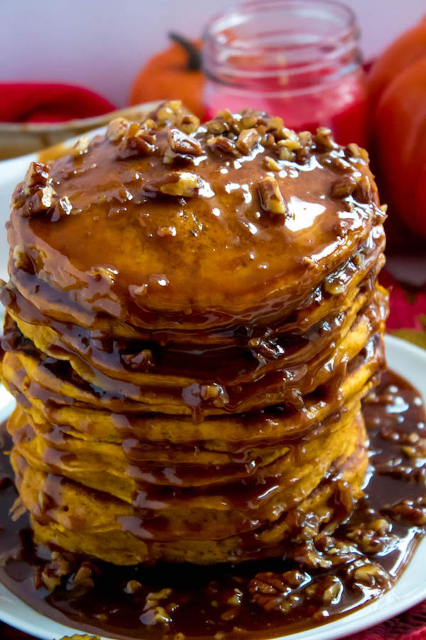 These Pumpkin Pancakes are light, fluffy and has the perfect amount of pumpkin and spice flavour! Topped with a rich and delicious Maple Pecan Praline Syrup, these irresistible pancakes are the perfect fall breakfast!