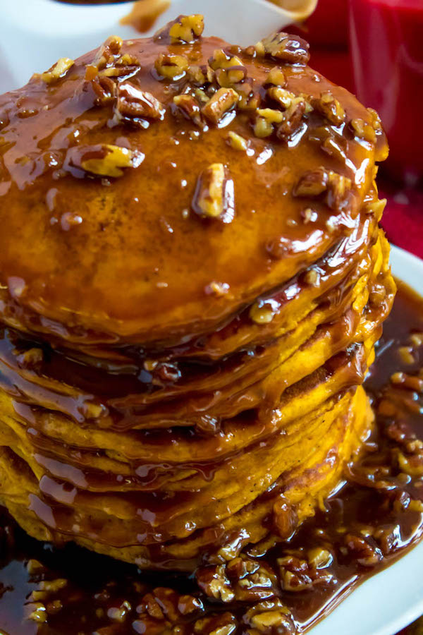 These Pumpkin Pancakes are light, fluffy and has the perfect amount of pumpkin and spice flavour! Topped with a rich and delicious Maple Pecan Praline Syrup, these irresistible pancakes are the perfect fall breakfast!