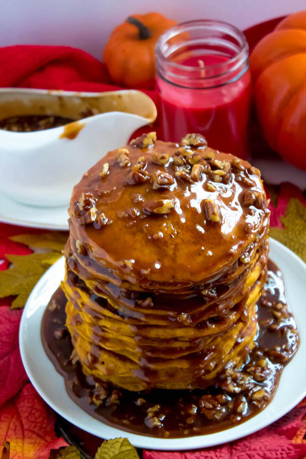 These Pumpkin Pancakes are light, fluffy and has the perfect amount of pumpkin and spice flavour! Topped with a rich and delicious Maple Pecan Praline Syrup, these irresistible pancakes are the perfect fall breakfast!