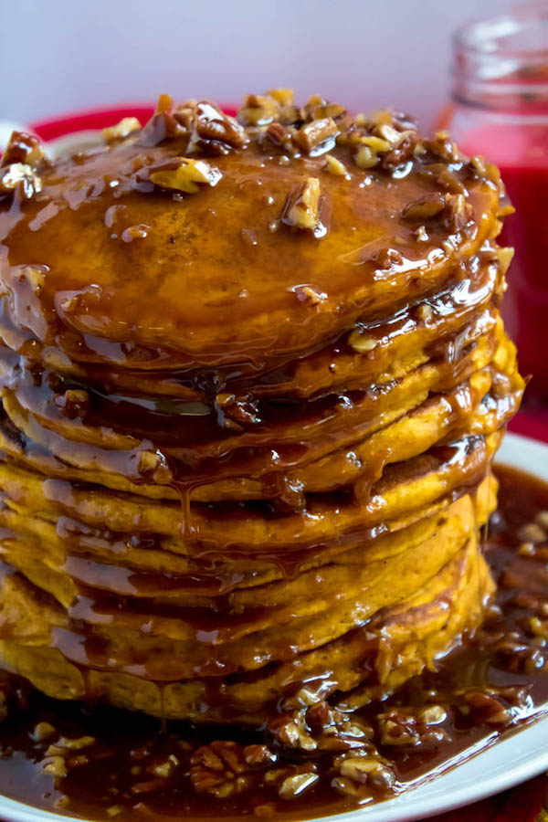 These Pumpkin Pancakes are light, fluffy and has the perfect amount of pumpkin and spice flavour! Topped with a rich and delicious Maple Pecan Praline Syrup, these irresistible pancakes are the perfect fall breakfast!