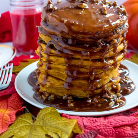 These Pumpkin Pancakes are light, fluffy and has the perfect amount of pumpkin and spice flavour! Topped with a rich and delicious Maple Pecan Praline Syrup, these irresistible pancakes are the perfect fall breakfast!