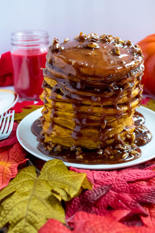 These Pumpkin Pancakes are light, fluffy and has the perfect amount of pumpkin and spice flavour! Topped with a rich and delicious Maple Pecan Praline Syrup, these irresistible pancakes are the perfect fall breakfast!