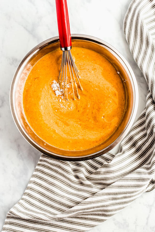 mixing wet and dry ingredients for pumpkin pancakes