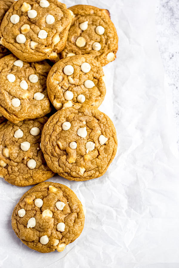 white chocolate chip pumpkin cookies on parchment paper
