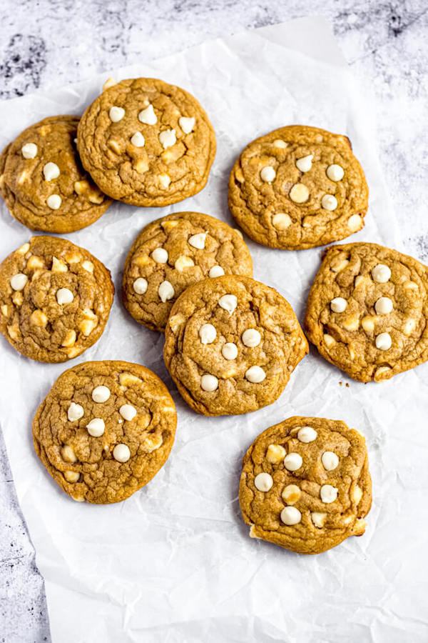 white chocolate chip pumpkin cookies on parchment paper