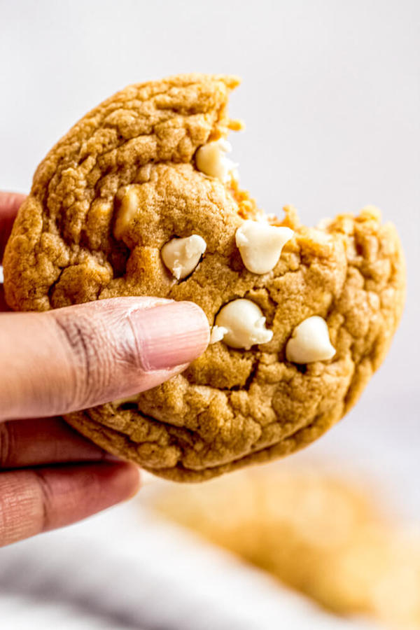 holding up a bite of chocolate chip pumpkin cookie