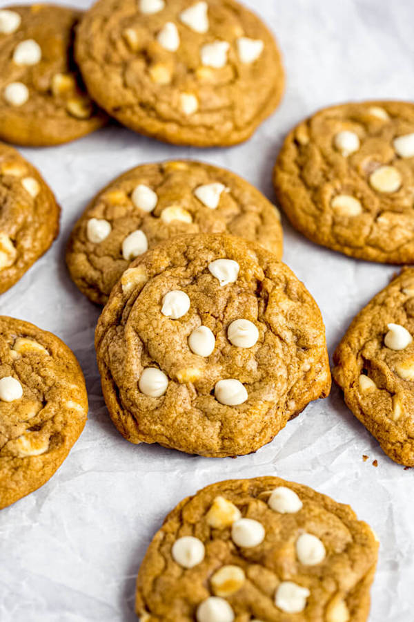 white chocolate chip pumpkin cookies on parchment paper