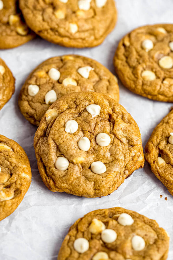 white chocolate chip pumpkin cookies on parchment paper