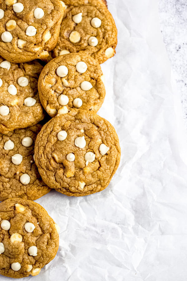 white chocolate chip pumpkin cookies on parchment paper