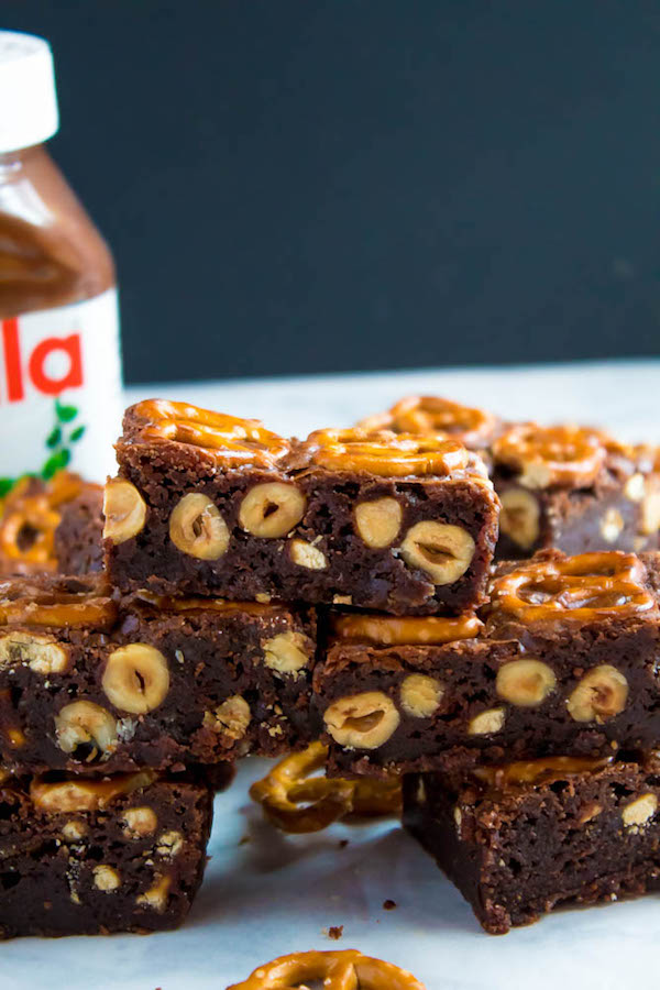 Salty meets sweet in these Nutella Pretzel Brownies! A perfectly fudgy Nutella brownie with roasted hazelnuts and salty pretzels mixed in. This decadent dessert will satisfy all of your salty and sweet cravings!