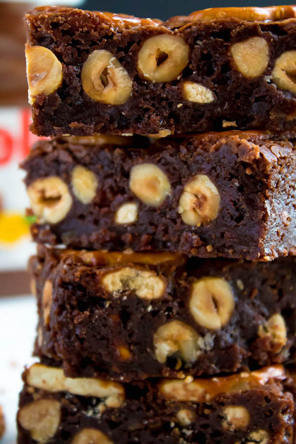 Salty meets sweet in these Nutella Pretzel Brownies! A perfectly fudgy Nutella brownie with roasted hazelnuts and salty pretzels mixed in. This decadent dessert will satisfy all of your salty and sweet cravings!