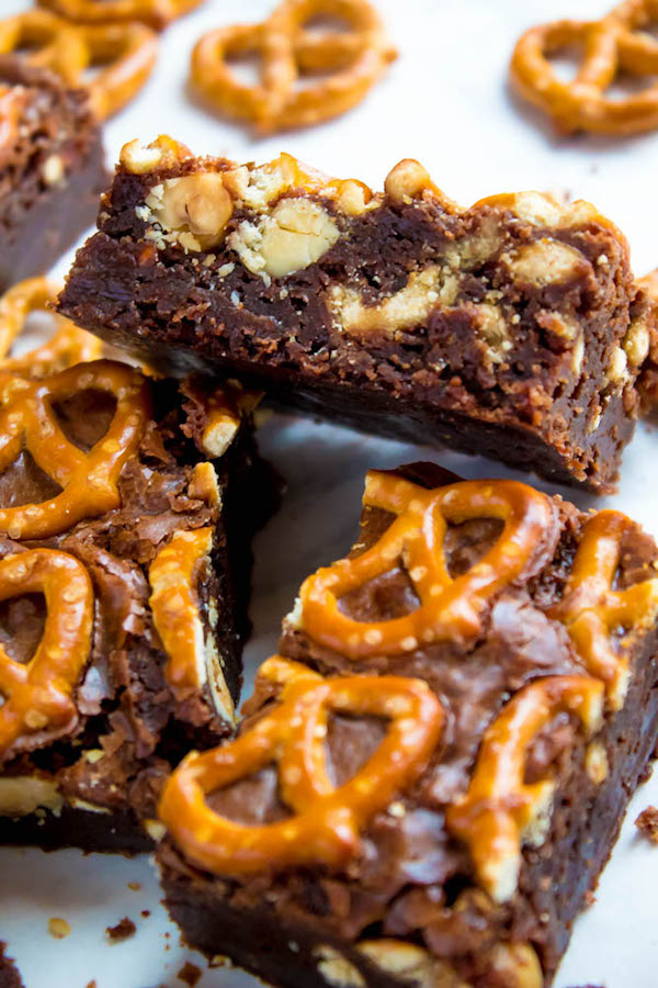 Salty meets sweet in these Nutella Pretzel Brownies! A perfectly fudgy Nutella brownie with roasted hazelnuts and salty pretzels mixed in. This decadent dessert will satisfy all of your salty and sweet cravings!