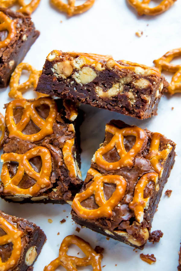 Salty meets sweet in these Nutella Pretzel Brownies! A perfectly fudgy Nutella brownie with roasted hazelnuts and salty pretzels mixed in. This decadent dessert will satisfy all of your salty and sweet cravings!