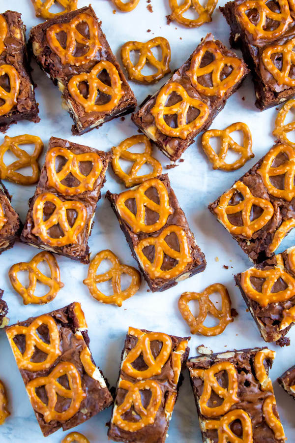 Salty meets sweet in these Nutella Pretzel Brownies! A perfectly fudgy Nutella brownie with roasted hazelnuts and salty pretzels mixed in. This decadent dessert will satisfy all of your salty and sweet cravings!