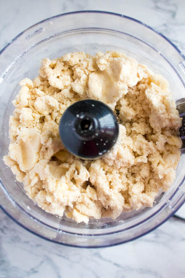 adding cold water to perfect pie crust with food processor