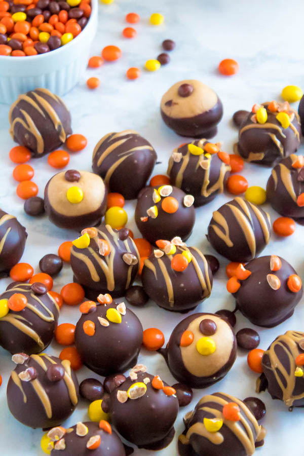 Reese's Pieces Peanut Butter Truffles— smooth and creamy peanut butter balls, loaded with mini Reese's Pieces, coated with dark chocolate and drizzled with melted peanut butter!