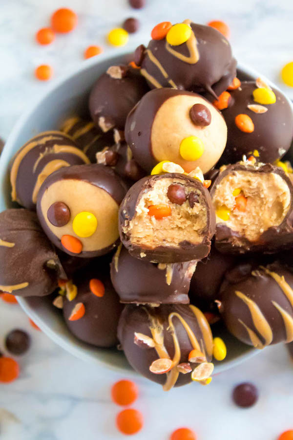 Reese's Pieces Peanut Butter Truffles— smooth and creamy peanut butter balls, loaded with mini Reese's Pieces, coated with dark chocolate and drizzled with melted peanut butter!