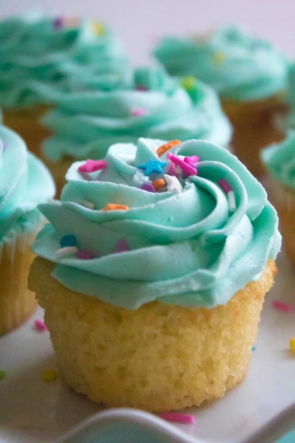 These Vanilla Cupcakes are light, fluffy and incredibly moist! Topped with a creamy and Dreamy Vanilla Buttercream, these are the best cupcakes for a birthday party or any event!