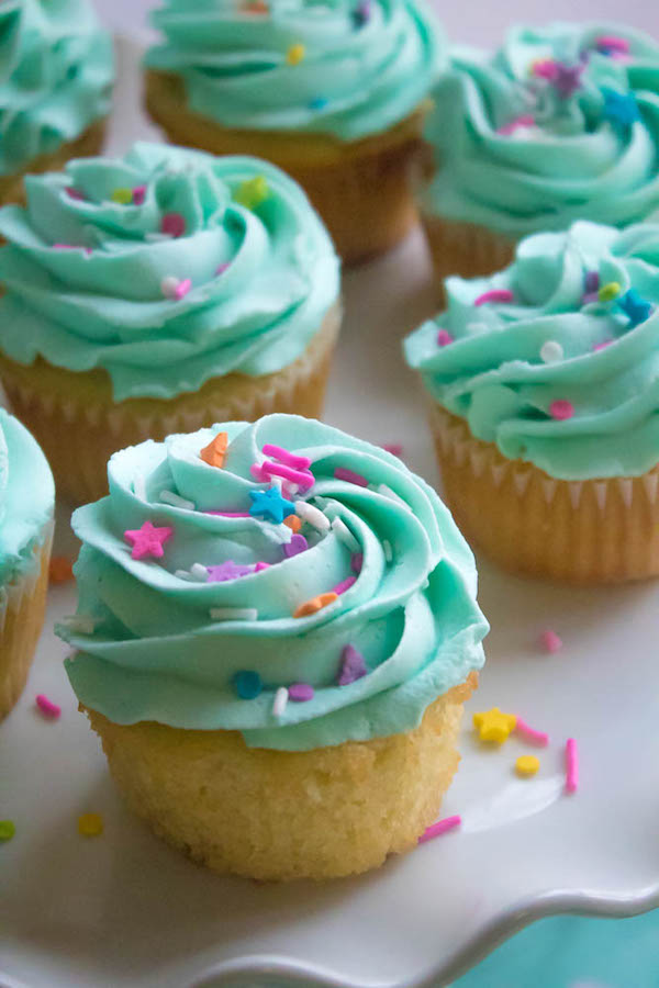 These Vanilla Cupcakes are light, fluffy and incredibly moist! Topped with a creamy and Dreamy Vanilla Buttercream, these are the best cupcakes for a birthday party or any event!