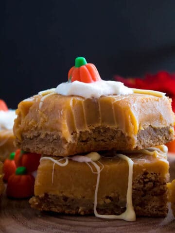 These White Chocolate Pumpkin Spice Fudge Blondies consist of a spiced blondie and white chocolate pumpkin spice fudge on top! These delicious pumpkin bars are the perfect treat for fall and Thanksgiving!