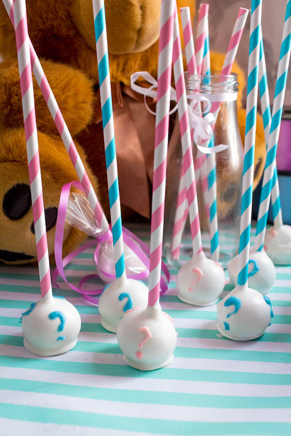 These Gender Reveal Cake Pops are a fun and cute way to surprise your baby shower guests! Once they bite into it, the pink or blue cake inside will reveal if it's a boy or girl!