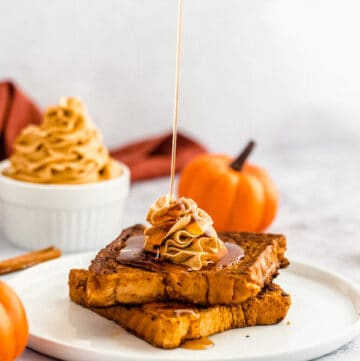 pumpkin French toast topped with icing sugar, maple syrup and whipped pumpkin spice honey butter