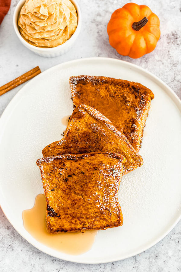 pumpkin French toast topped with icing sugar and maple syrup 