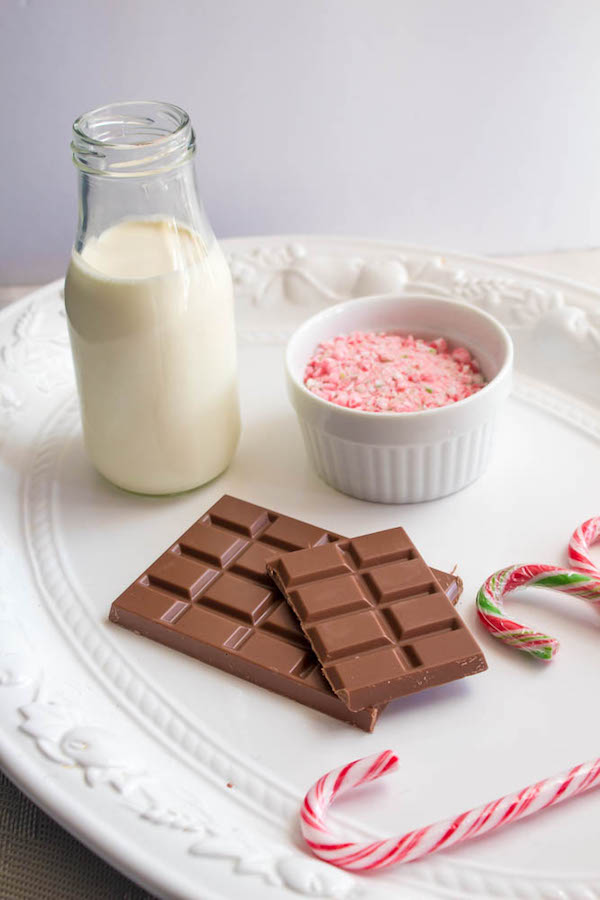 This Candy Cane Hot Chocolate is a warm and cozy Holiday drink perfect for warming up to the cold weather. With a candy cane lined rim, peppermint hot chocolate filled with crushed candy canes, and a peppermint whipped cream topping, this drink screams Christmas! 