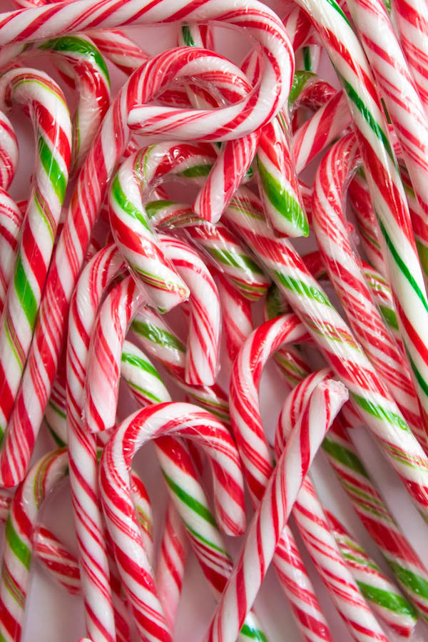This Candy Cane Hot Chocolate is a warm and cozy Holiday drink perfect for warming up to the cold weather. With a candy cane lined rim, peppermint hot chocolate filled with crushed candy canes, and a peppermint whipped cream topping, this drink screams Christmas! 