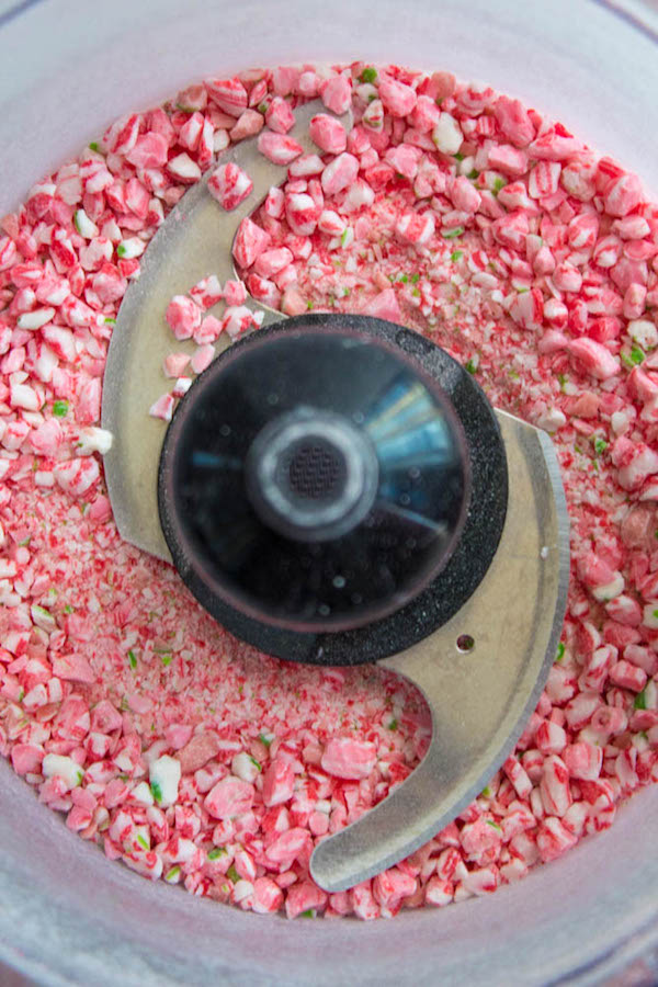 This Candy Cane Hot Chocolate is a warm and cozy Holiday drink perfect for warming up to the cold weather. With a candy cane lined rim, peppermint hot chocolate filled with crushed candy canes, and a peppermint whipped cream topping, this drink screams Christmas! 