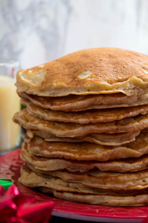 These fluffy, golden Eggnog Pancakes are spiked with rum and have a delicious Eggnog flavour. Top this stack of Christmas flapjacks with fresh cranberry syrup for a delightful holiday breakfast!