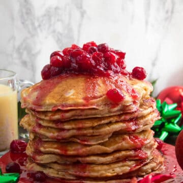 These fluffy, golden Eggnog Pancakes are spiked with rum and have a delicious Eggnog flavour. Top this stack of Christmas flapjacks with fresh cranberry syrup for a delightful holiday breakfast!