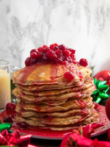 These fluffy, golden Eggnog Pancakes are spiked with rum and have a delicious Eggnog flavour. Top this stack of Christmas flapjacks with fresh cranberry syrup for a delightful holiday breakfast!