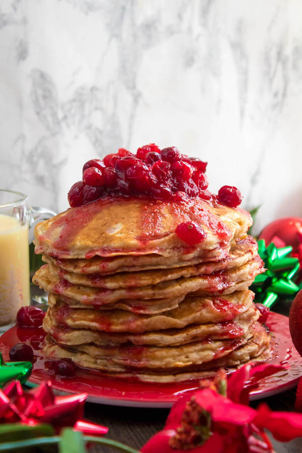 These fluffy, golden Eggnog Pancakes are spiked with rum and have a delicious Eggnog flavour. Top this stack of Christmas flapjacks with fresh cranberry syrup for a delightful holiday breakfast!