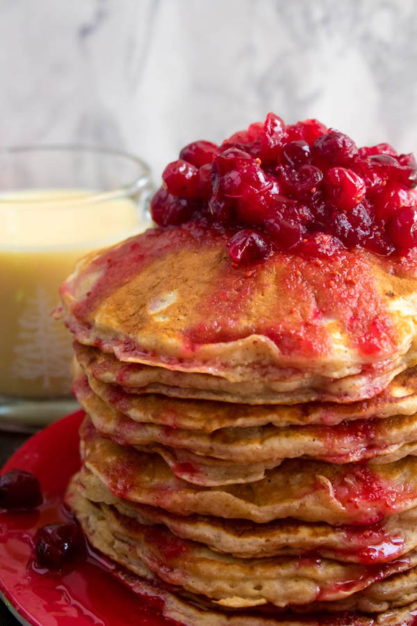 These fluffy, golden Eggnog Pancakes are spiked with rum and have a delicious Eggnog flavour. Top this stack of Christmas flapjacks with fresh cranberry syrup for a delightful holiday breakfast!