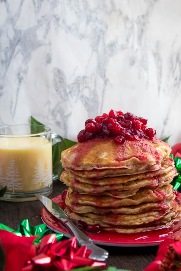 These fluffy, golden Eggnog Pancakes are spiked with rum and have a delicious Eggnog flavour. Top this stack of Christmas flapjacks with fresh cranberry syrup for a delightful holiday breakfast!