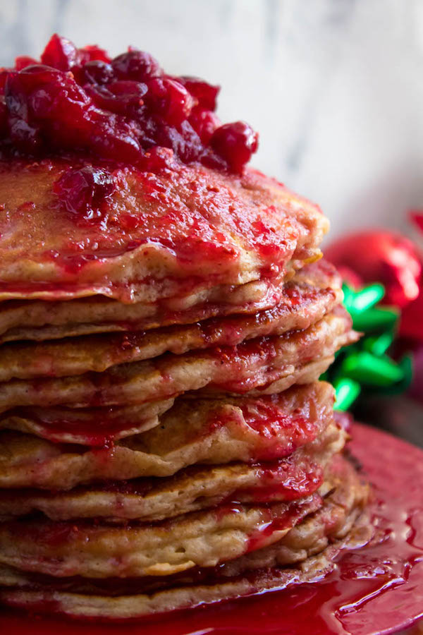 These fluffy, golden Eggnog Pancakes are spiked with rum and have a delicious Eggnog flavour. Top this stack of Christmas flapjacks with fresh cranberry syrup for a delightful holiday breakfast!