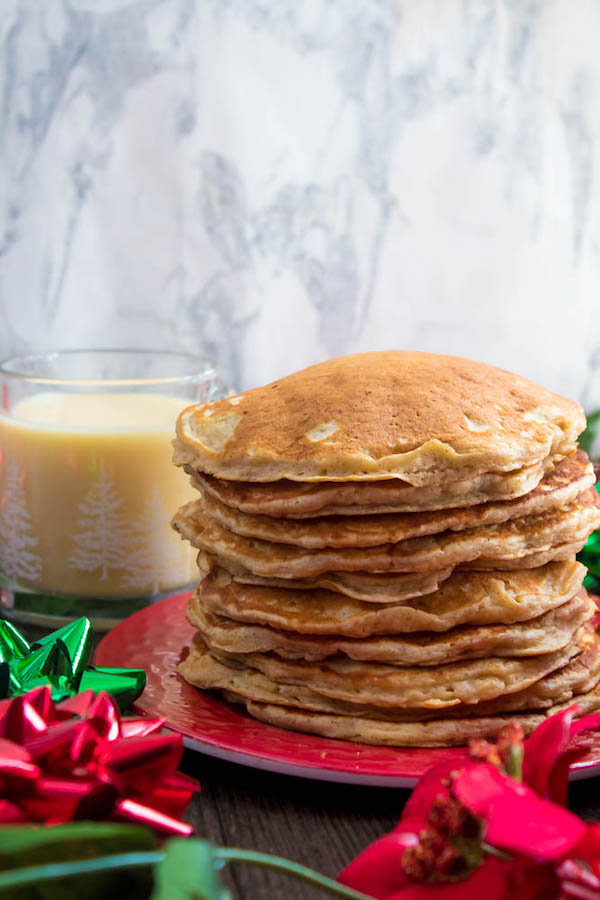 These fluffy, golden Eggnog Pancakes are spiked with rum and have a delicious Eggnog flavour. Top this stack of Christmas flapjacks with fresh cranberry syrup for a delightful holiday breakfast!