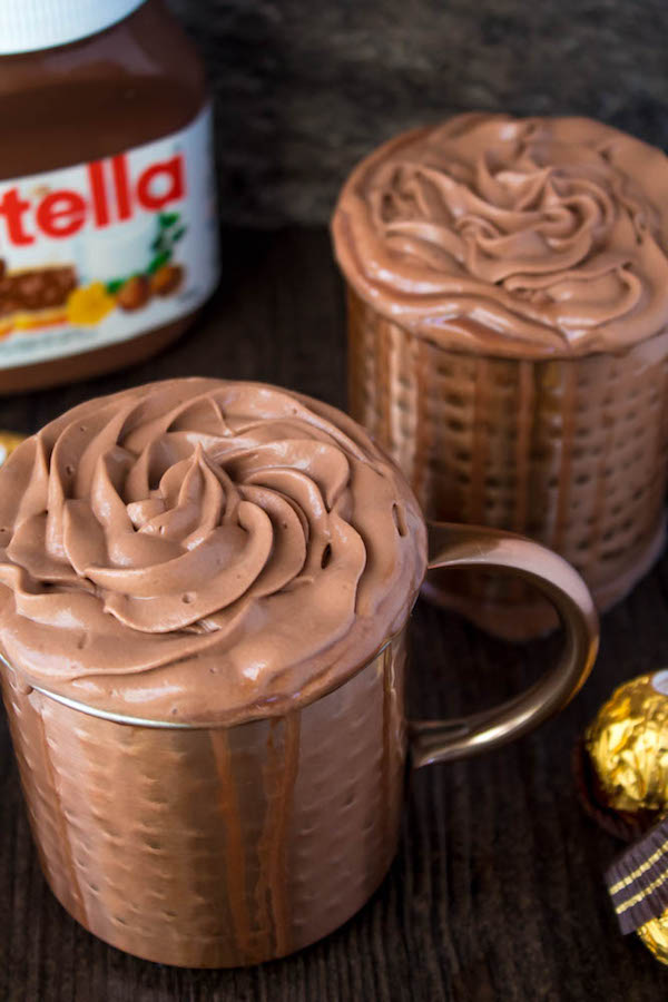 Nutella lovers gather around! This Nutella Hot Chocolate is thick, rich, creamy and decadent! Topped with Nutella Whipped Cream, melted Nutella, chopped hazelnuts and Ferrero Rochers — this is the ultimate drink for every Nutella fanatic!
