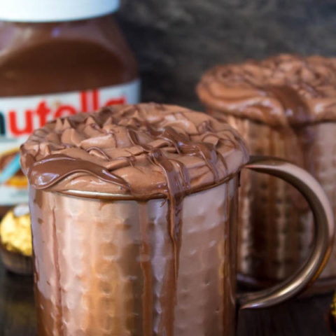 Nutella lovers gather around! This Nutella Hot Chocolate is thick, rich, creamy and decadent! Topped with Nutella Whipped Cream, melted Nutella, chopped hazelnuts and Ferrero Rochers — this is the ultimate drink for every Nutella fanatic!