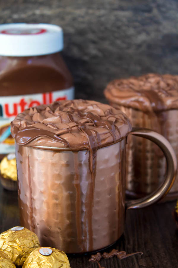 Nutella lovers gather around! This Nutella Hot Chocolate is thick, rich, creamy and decadent! Topped with Nutella Whipped Cream, melted Nutella, chopped hazelnuts and Ferrero Rochers — this is the ultimate drink for every Nutella fanatic!