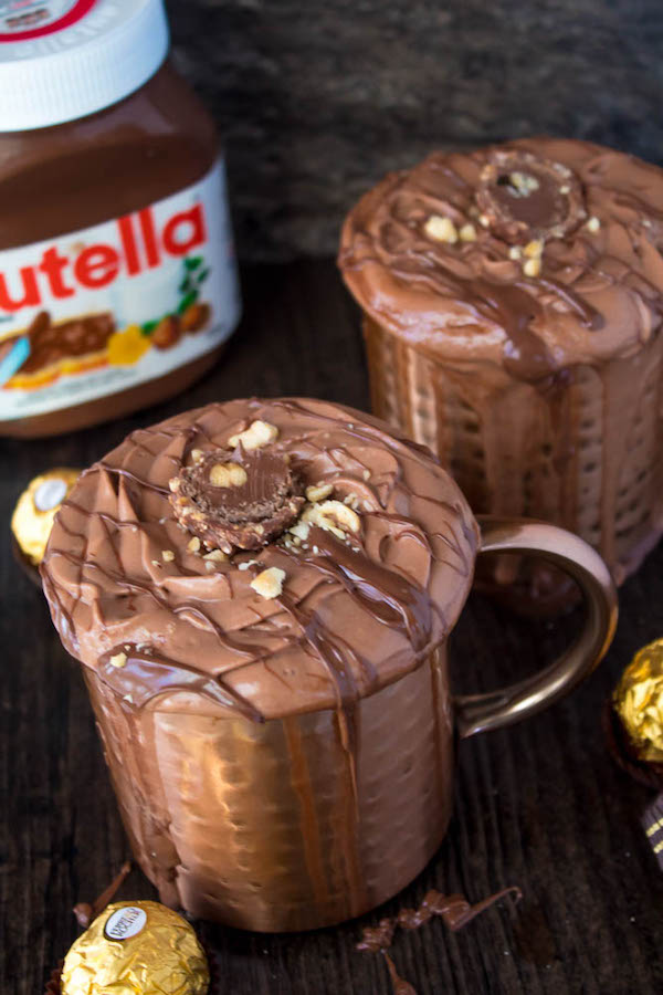 Nutella lovers gather around! This Nutella Hot Chocolate is thick, rich, creamy and decadent! Topped with Nutella Whipped Cream, melted Nutella, chopped hazelnuts and Ferrero Rochers — this is the ultimate drink for every Nutella fanatic!