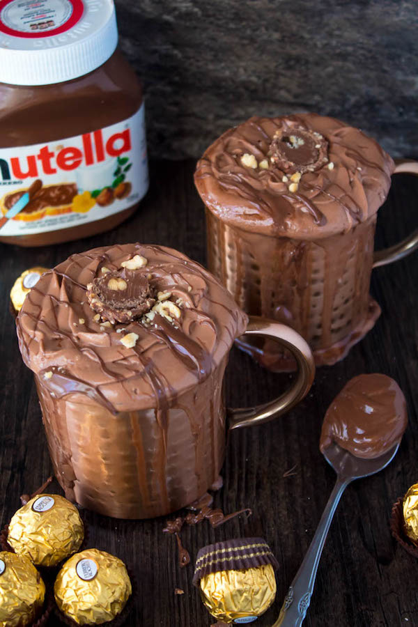 Nutella lovers gather around! This Nutella Hot Chocolate is thick, rich, creamy and decadent! Topped with Nutella Whipped Cream, melted Nutella, chopped hazelnuts and Ferrero Rochers — this is the ultimate drink for every Nutella fanatic!