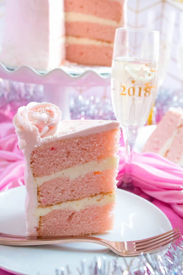 This Pink Champagne Cake is the perfect way to celebrate New Years Eve. Layers of Champagne infused cake, filled with a Champagne infused Buttercream and frosted with a light and fluffy vanilla buttercream — there's no better way to start the new year!