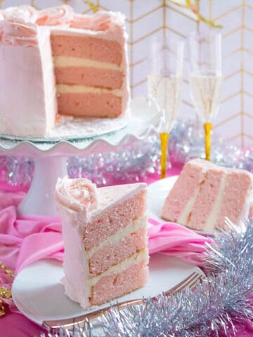 This Pink Champagne Cake is the perfect way to celebrate New Years Eve. Layers of Champagne infused cake, filled with a Champagne infused Buttercream and frosted with a light and fluffy vanilla buttercream — there's no better way to start the new year!