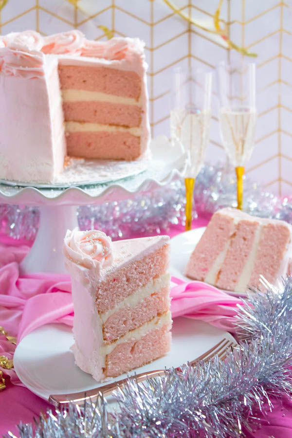 This Pink Champagne Cake is the perfect way to celebrate New Years Eve. Layers of Champagne infused cake, filled with a Champagne infused Buttercream and frosted with a light and fluffy vanilla buttercream — there's no better way to start the new year!