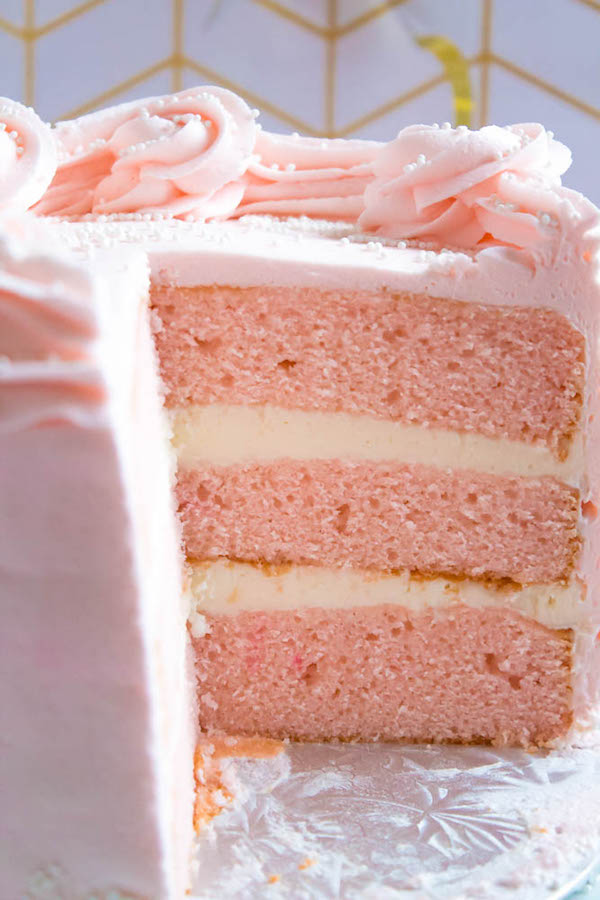 This Pink Champagne Cake is the perfect way to celebrate New Years Eve. Layers of Champagne infused cake, filled with a Champagne infused Buttercream and frosted with a light and fluffy vanilla buttercream — there's no better way to start the new year!