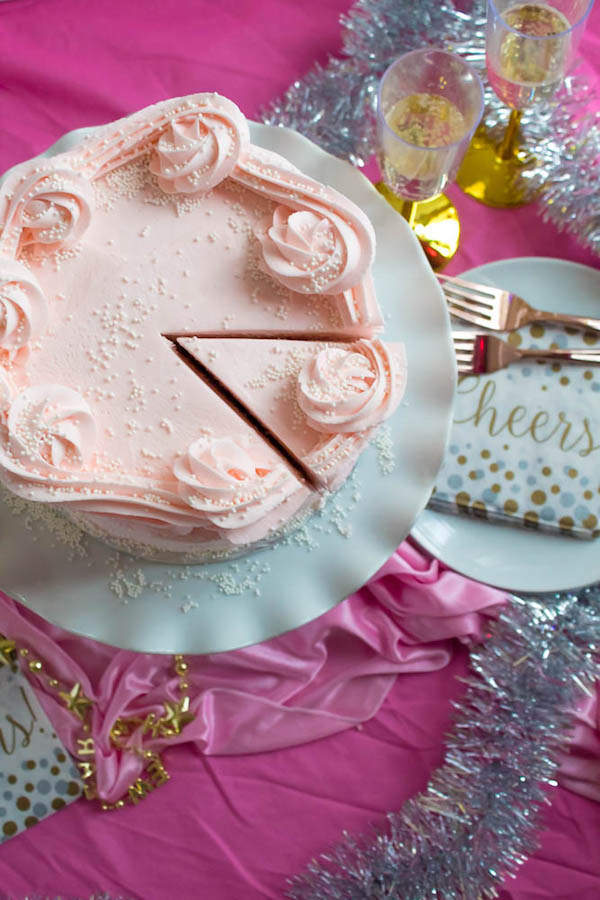 This Pink Champagne Cake is the perfect way to celebrate New Years Eve. Layers of Champagne infused cake, filled with a Champagne infused Buttercream and frosted with a light and fluffy vanilla buttercream — there's no better way to start the new year!