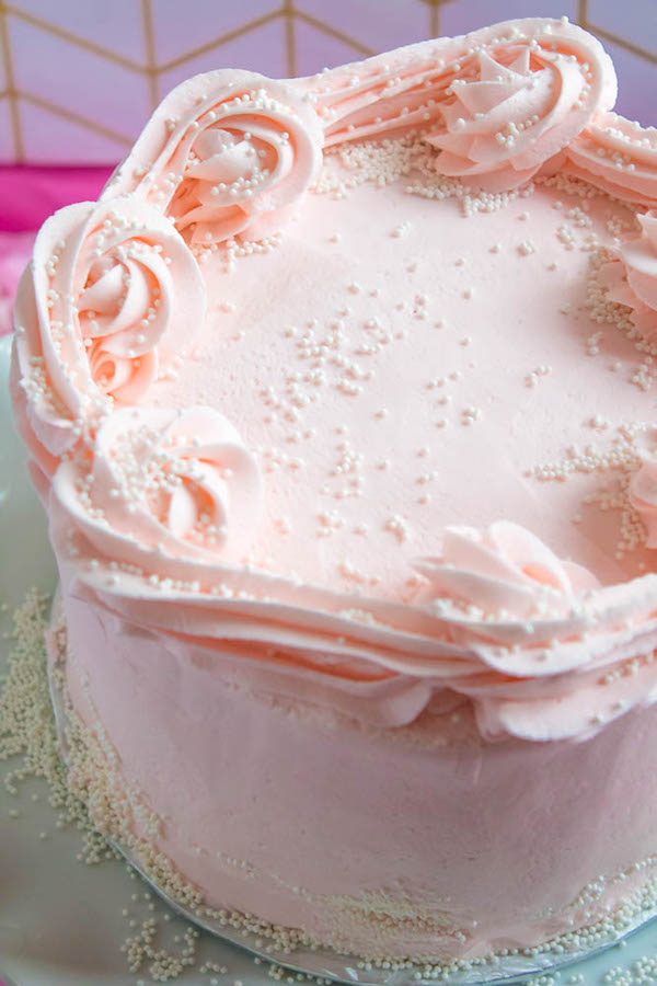 This Pink Champagne Cake is the perfect way to celebrate New Years Eve. Layers of Champagne infused cake, filled with a Champagne infused Buttercream and frosted with a light and fluffy vanilla buttercream — there's no better way to start the new year!